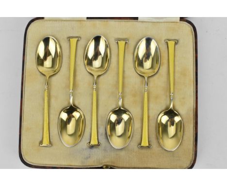 A set of six mid 20th century silver gilt and yellow enamelled coffee spoons, Birmingham 1940 by Barker Brothers Silver Ltd, 