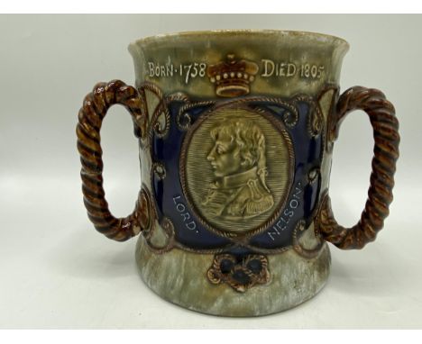 An early 20th century Royal Doulton commemorative tyg, the generous cylindrical body applied with three rope handles, one sid