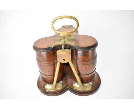 A Victorian oak tea caddy fashioned as three removable barrels, with a hinged lid, brass carrying handle and lock, on a trefo