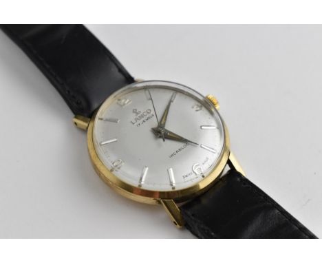 A 1960's gents Lanco manual wind 17 jewels Incabloc 9ct gold wristwatch having a silvered dial with baton hour markers, the c