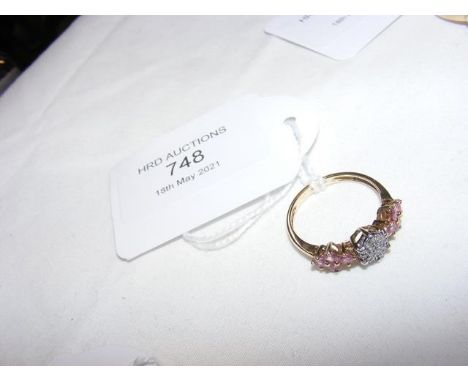 A diamond and pink stone ring in gold setting