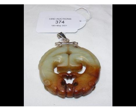 A jade pendant with silver mount - 5.5cm diameter, together with one other jade pendant of buddha 