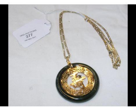 A circular jade pendant on 18ct chain