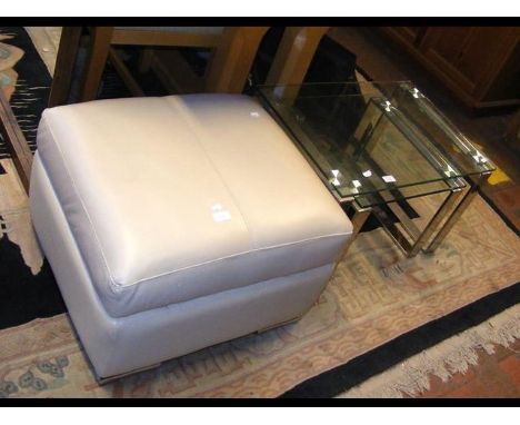 A nest of glass tables, together with a cream pouffe 