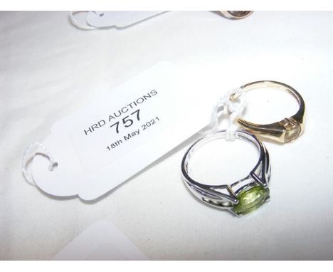 A ladies green stone dress ring and one other