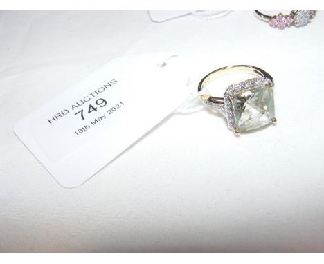 A square set dress ring with diamond chips to surround and shoulder in 9ct setting