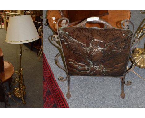 A brass telescopic central stem standard lamp and a copper and wrought iron eagle embossed fire screen (2)
