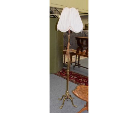 Late Victorian brass adjustable standard lamp, with four paw feet 