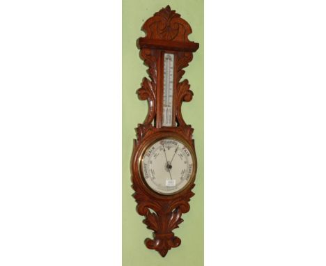 An oak cased aneroid barometer 