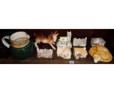Group of five china cottages, a Melba ware goat, a sleeping china cat and a large Jersey Pottery jug