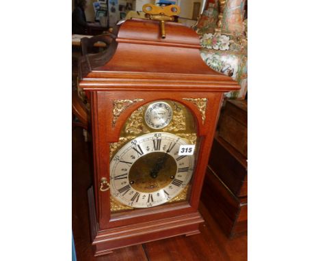 Modern triple chiming 8 day bracket clock with brass dial and silvered chapter ring in mahogany case from E.J. Goodfellow of 