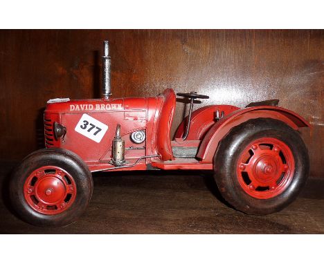 Modern painted tin plate model of an old David Brown tractor