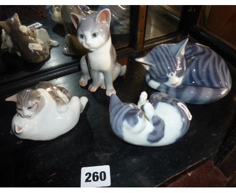 Four Royal Copenhagen china cat figurines - nos. 303, 071, 515 and 057