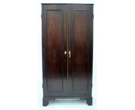 A GEORGE III MAHOGANY ESTATE CUPBOARD with twin panelled doors opening to reveal a fitted interior, with further doors concea
