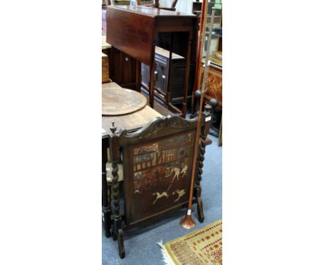 AN EARLY 20TH CENTURY OAK FIRE SCREEN with embossed leather panel with painted decoration depicting a hunt outside an inn, 56