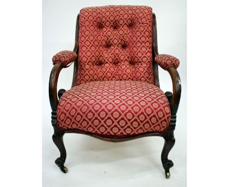 A VICTORIAN MAHOGANY BUTTON BACK LIBRARY ARMCHAIR with shepherd crook pad upholstered arms and overstuffed upholstered seat a