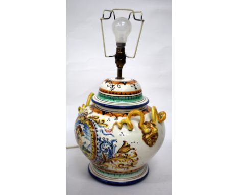 A MAJOLICA TIN GLAZED POTTERY LAMP BASE in the renaissance style with mask handles and pleated silk shade