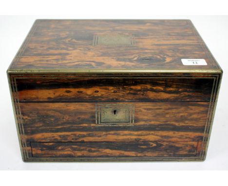 A VICTORIAN ROSEWOOD AND BRASS BOUND DRESSING BOX the lifting lid opening to reveal a fitted interior with silver plate toppe