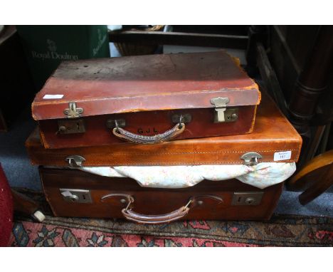 AND OLD LEATHER SUITCASE, 60.5cm wide together with two other leather suitcases (AF), two vintage quilts and two cushion cove