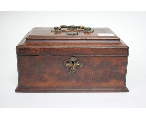 AN EARLY TO MID 19TH CENTURY MAHOGANY TEA CADDY with a scrolling gilt handle and three compartments within, 25.5cm wide 