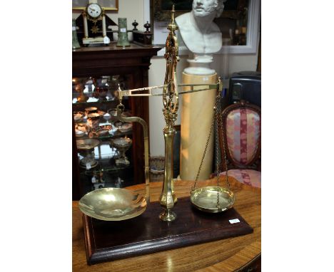 A SET OF VICTORIAN BRASS SHOP SCALES the rectangular mahogany base with cushion moulded edge, the brass scales stamped Parnal