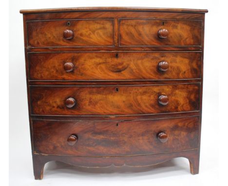 A 19TH CENTURY MAHOGANY BOW FRONTED CHEST OF DRAWERS with turned knob handles and bracket feet, 106cm wide x 101cm high