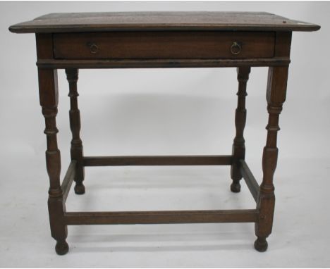 AN ANTIQUE OAK SIDE TABLE, the single frieze drawer with ring handles and standing on turned legs with vase shaped decoration