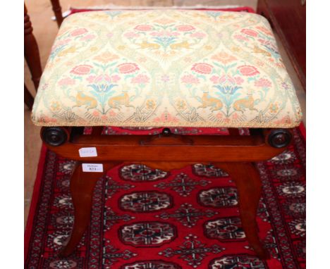 AN EMPIRE STYLE MAHOGANY STOOL with overstuffed upholstered seat resting on shaped support with ebonised roundels and shaped 