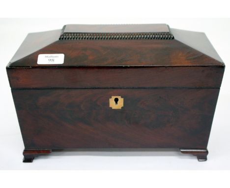 A REGENCY MAHOGANY TEA CADDY of sarcophagus form on small bracket feet, the interior with two lidded compartments and central