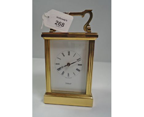 A brass carriage time piece, with enamel Roman dial