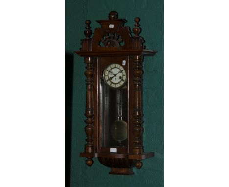 A Gustav Becker type walnut cased Vienna wall clock, the pierced bobbin turned pediment over glazed door within half turned p