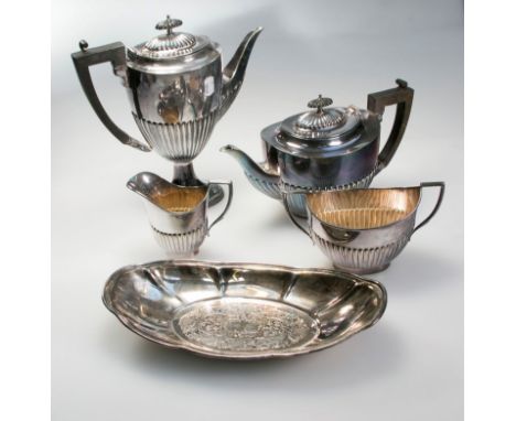 An Edwardian demi-reeded four piece EPNS tea service, a covered vegetable tureen and an unassociated oval tray