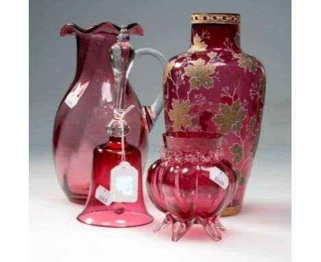 Nine pieces of Victorian and later cranberry glass, including table bell, wavy-rim jug, two enamel decorated vases and other 