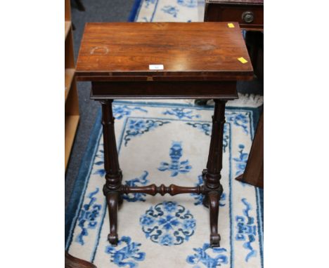 A William IV figured rosewood lady's fold-over work table/card table, raised on spindle supports, 41 cm (16 in) wide