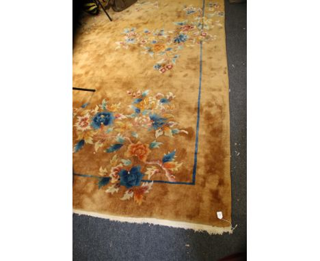 A large gold ground Chinese carpet with floral decoration