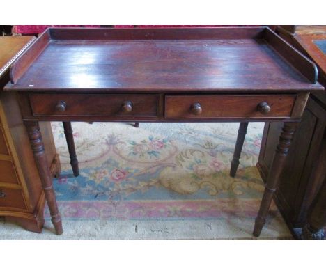 A Victorian mahogany two drawer washstand on ring turned supports.