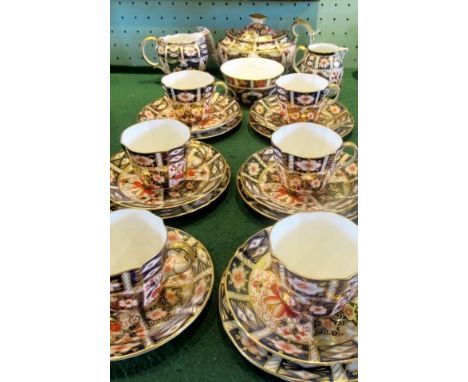 A Royal Crown Derby six piece tea service, comprising: teapot, milk &amp; cream jugs, sugar bowl and six trios. Condition Rep