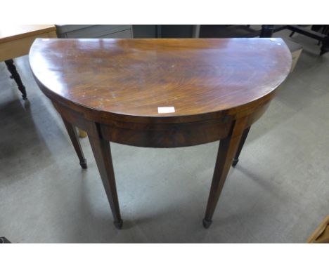 A George III mahogany demi-lune fold over card table 