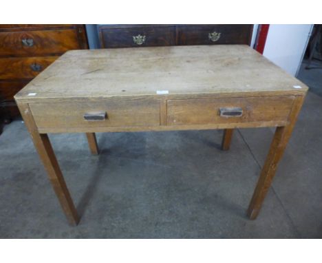 An Art Deco Heals style light oak two drawer desk, 74cms h, 101cms w, 61cms d 