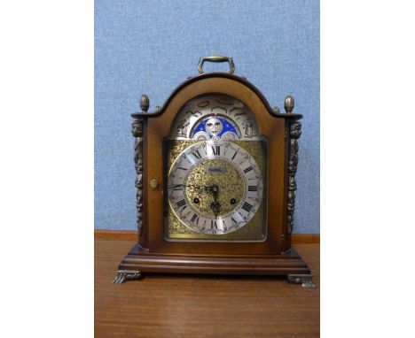 A German Hermle walnut mantle clock with moonphase rolling dial 
