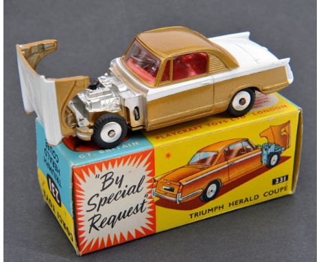 Corgi Toys Triumph Herald Coupe (231). Example in white and metallic gold with red interior. Example with smooth flat wheels.