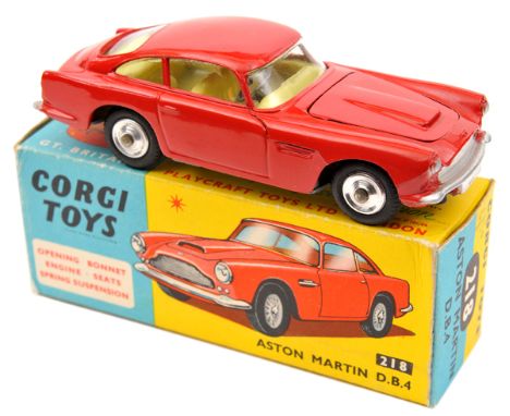 Corgi Toys Aston Martin D.B.4 (218). In red with yellow interior. Example with no bonnet vent and spun wheels. Boxed, Krona p