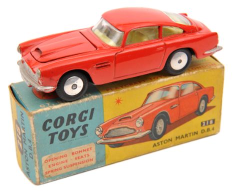 Corgi Toys Aston Martin D.B.4 (218). In red with yellow interior. Example with bonnet vent and spun wheels. Boxed, some age w