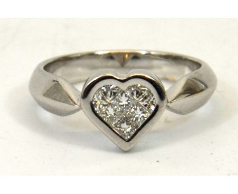 Heart shaped diamond set ring, eight stones approx 0.44ct, set in a heart shaped rub over setting in  18ct white gold (stampe