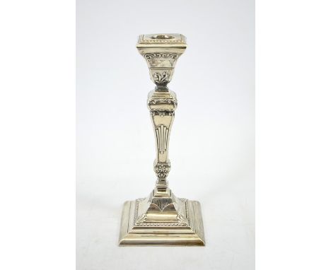 An Edwardian silver candlestick, Rococo square section baluster form, Henry Matthews, Birmingham 1904, 20cm high, weighted