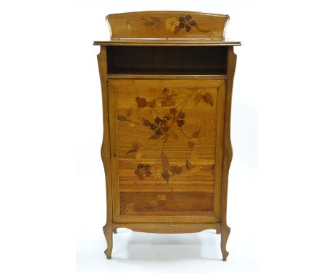 Emile Galle, an Art Nouveau marquetry cabinet, circa 1900, the cupboard door inlaid with specimen wood clematis, signed with 