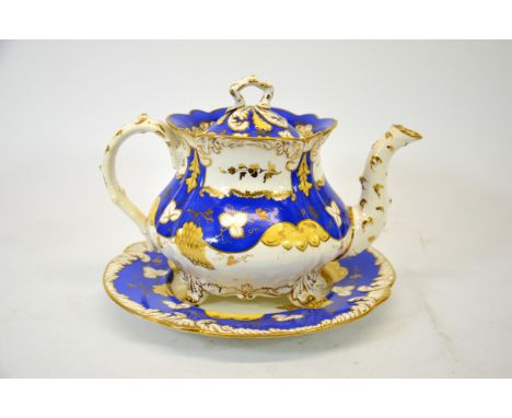 A Rockingham teapot and stand, pattern 835, relief moulded feather edge, painted with grapes and vine leaves, blue and yellow