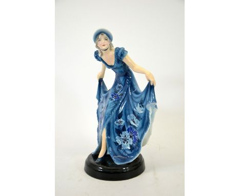 Stephan Dakon for Goldscheider, figure of a woman modelling a blue dress, circa 1931, model 6330, floral design and hat, inci