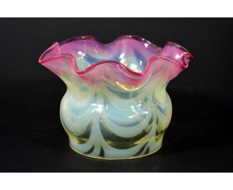 An Arts and Crafts glass light shade, cranberry tinted straw opal optic moulded, funnel form with draped curtain opaque mould