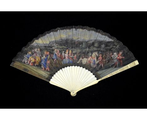 λ An early 18th century ivory fan, with ivory sticks and guards, the guards carved with figures and buildings, the leaf mount